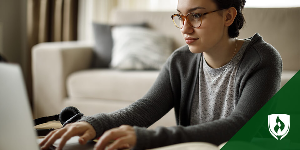 female student typing on laptop