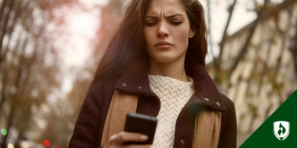 A recent graduate looks worried as she reads about student loan repayments starting in October