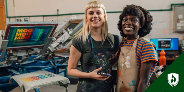 Two screen printing professionals smile at the camera