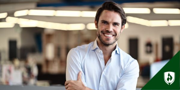 An accounting clerk smiles in front of a busy office