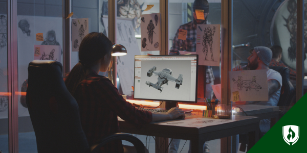 A designer works at her desktop computer in an office