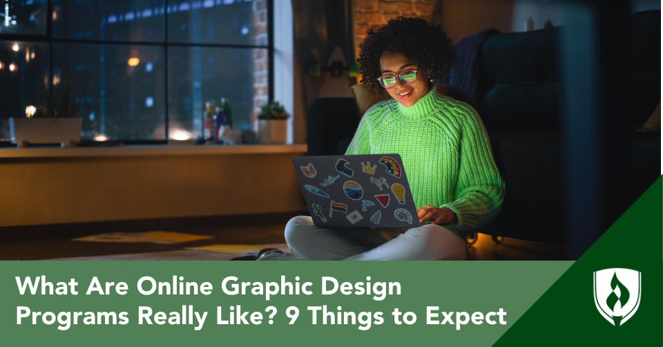 An online graphic design student sits on the floor, looking at her computer in a dark apartment