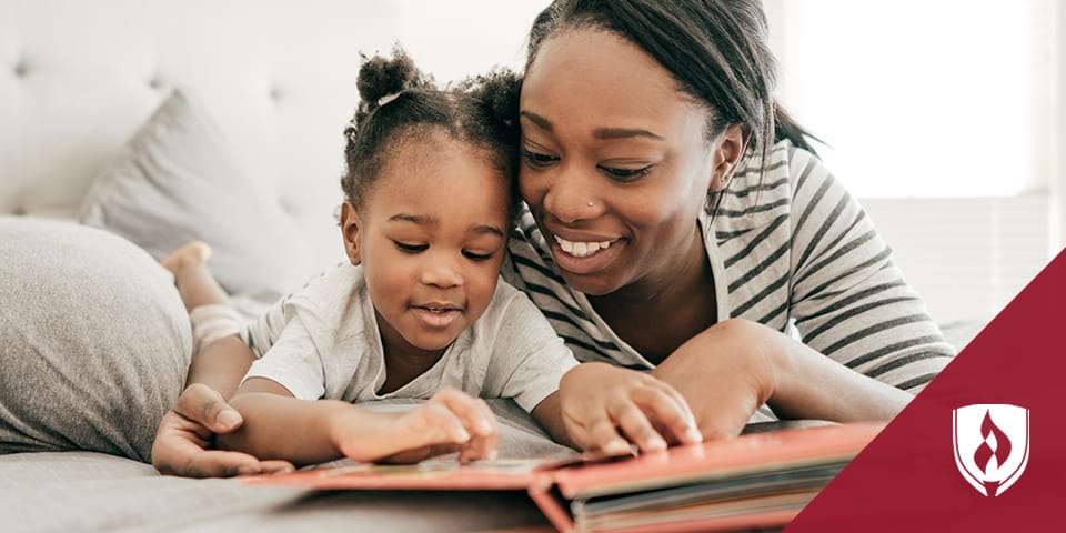 mother reading a book with young daughter