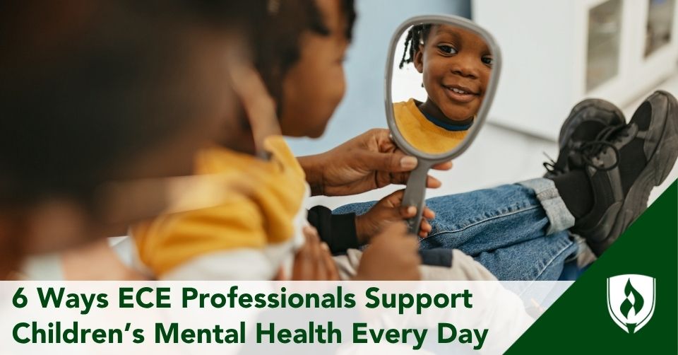 Adorable toddler smiles at his reflection in a mirror