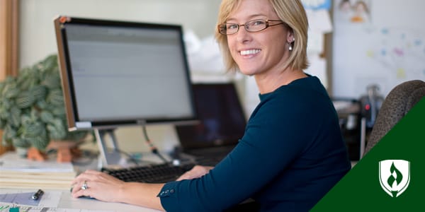 woman sitting at desk on computer