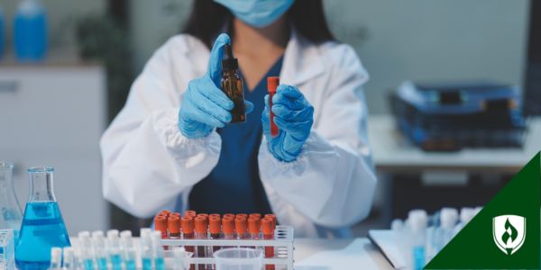 A lab technician holds up blood samples