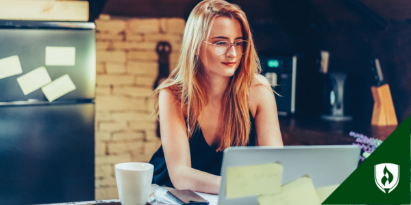 A student wearing glasses looks over human services and psych degree options on her computer