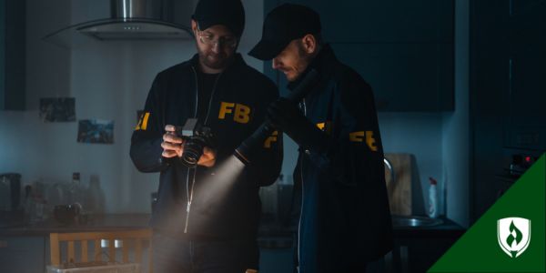 Two FBI criminal investigators in a dark room