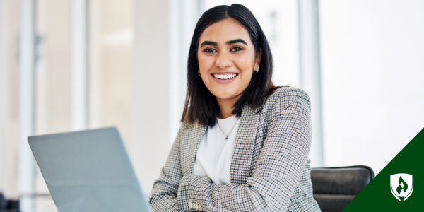 A paralegal smiles from her computer