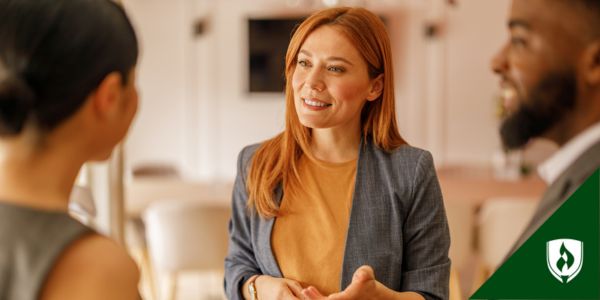 A paralegal meets with two attorneys to brief them on the schedule
