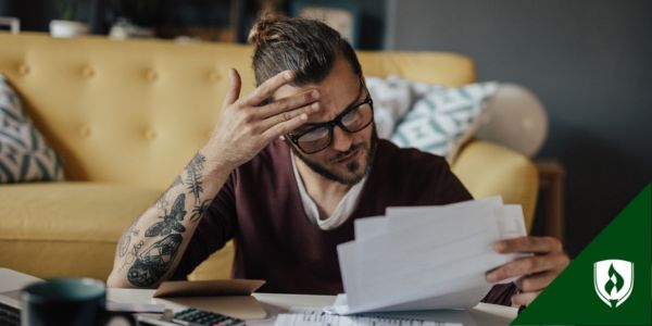 A man looks over documents with stress