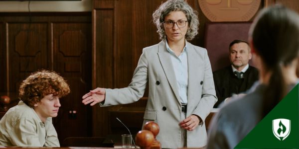 A court prosecutor gestures at a defendant