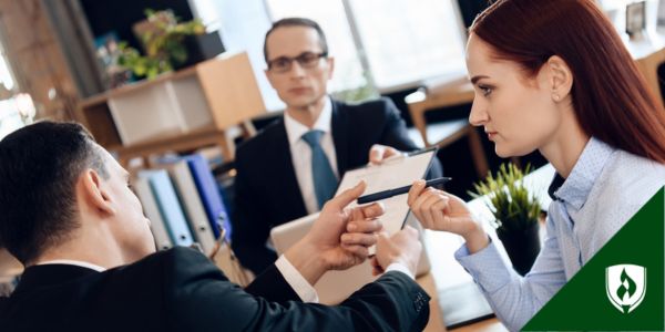 A couple sign divorce papers with an attorney