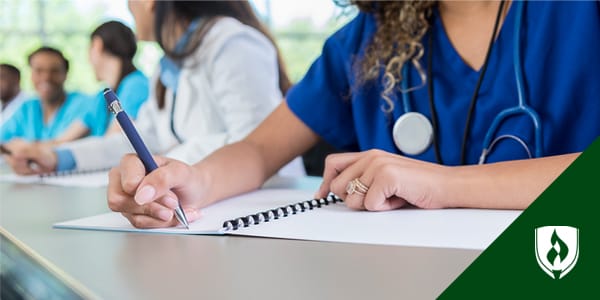 Photo of a female nursing student taking notes.