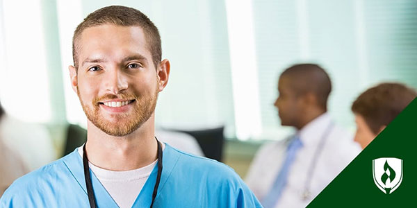 male in scrubs smiling