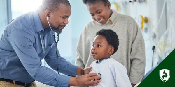 A pediatric nurse practitioner uses a stethoscope during a well child exam