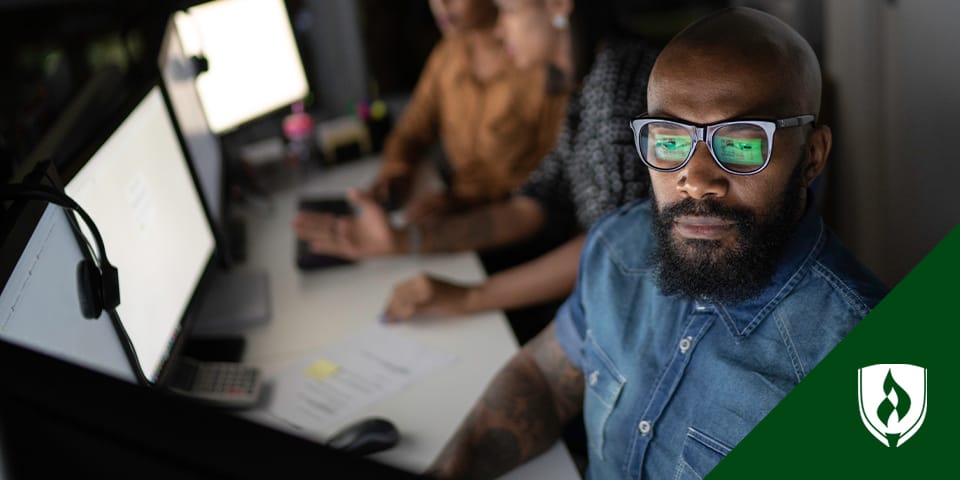 Photo of a man working at a computer.