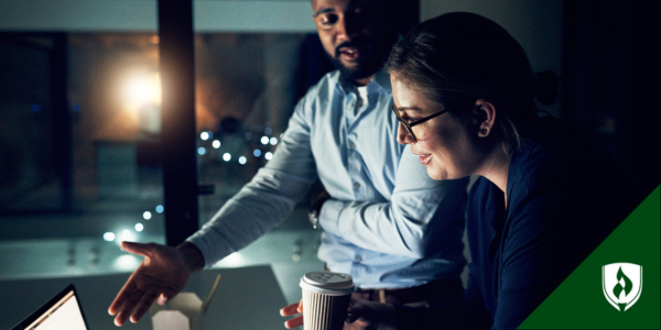 An e-commerce developer chats with her colleague while looking at their online platform