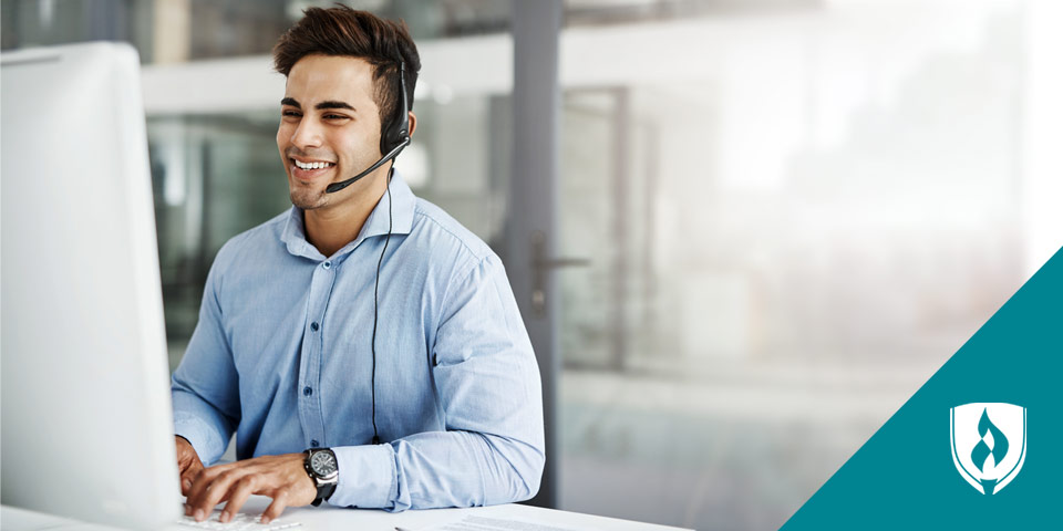 Man working on computer with a headset