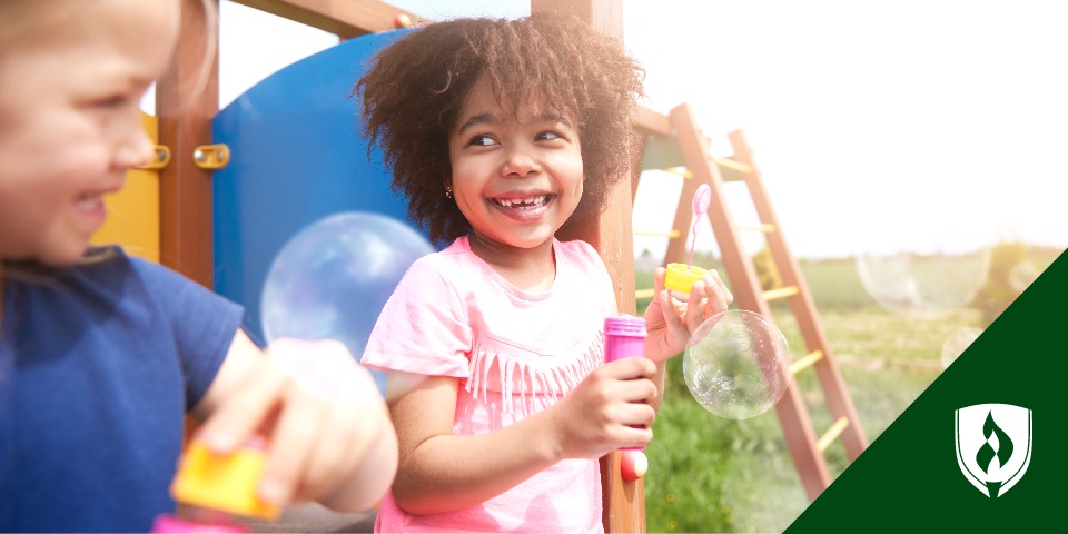 photo of two todlers playing and smiling