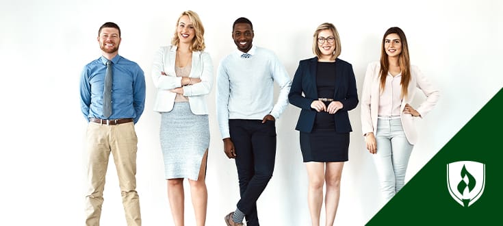 Photo of 5 professionally dressed people standing in a line.
