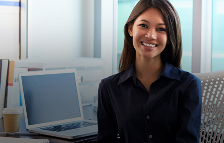 Female sitting at desk smiling