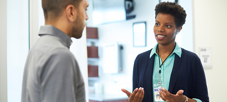 Smiling business woman talking to a colleague