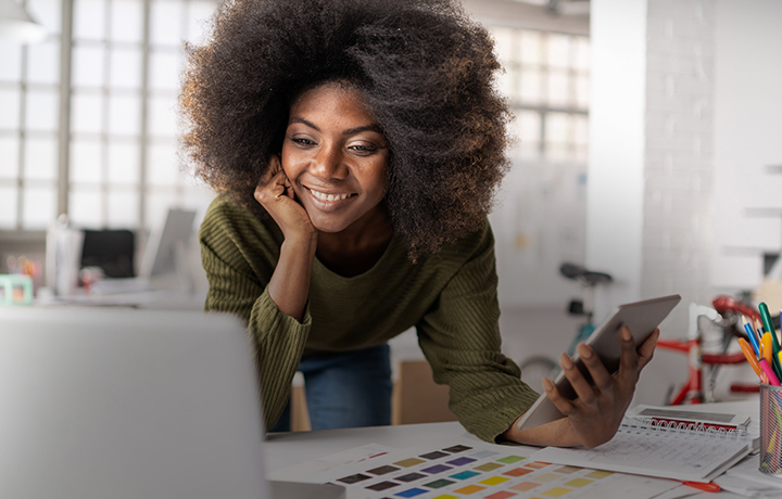 Woman smiling while working mobile