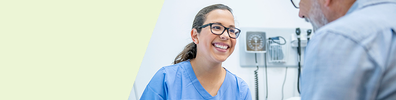 Smiling medical assistant helps a patient in a medical setting