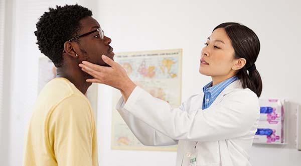 male patient getting knee checked by female nurse practitioner