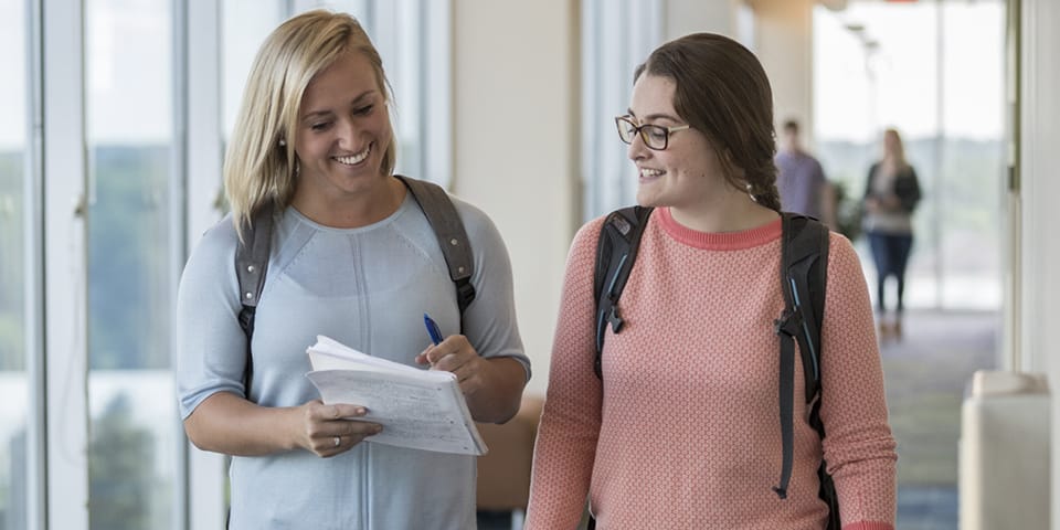 two female students walking in hallway